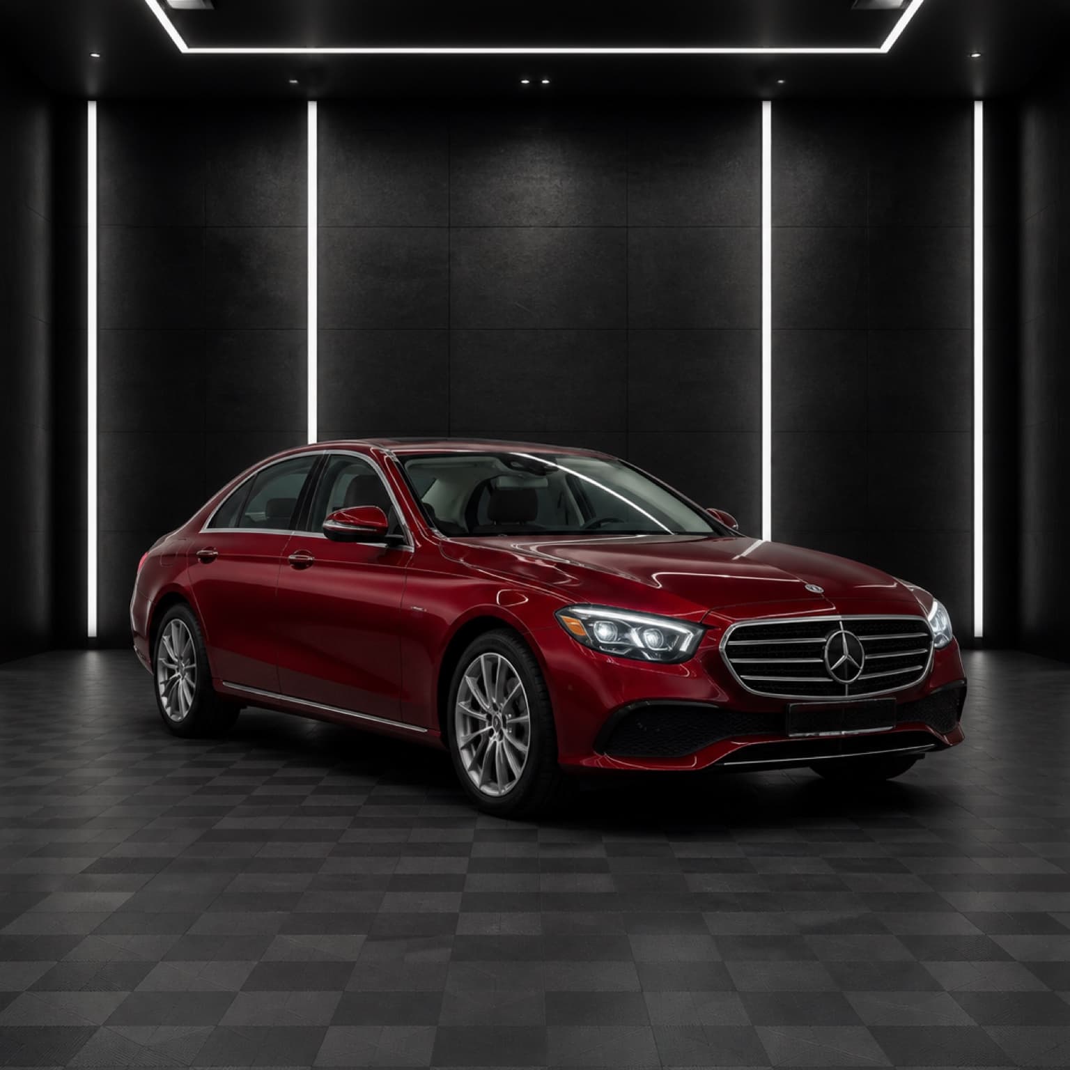Red Mercedes-Benz inside a dark automotive studio.