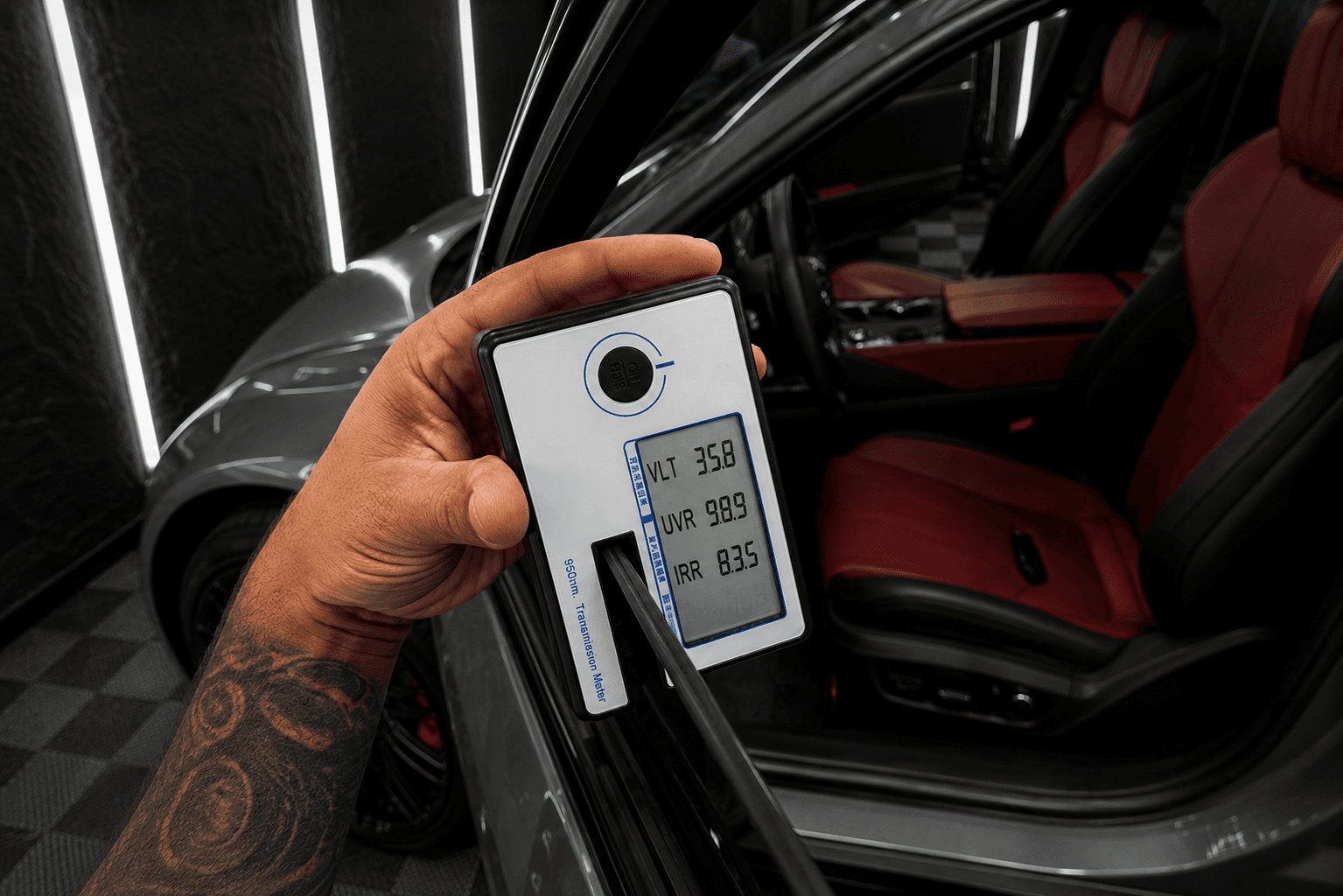 Window film being checked with a tint meter.